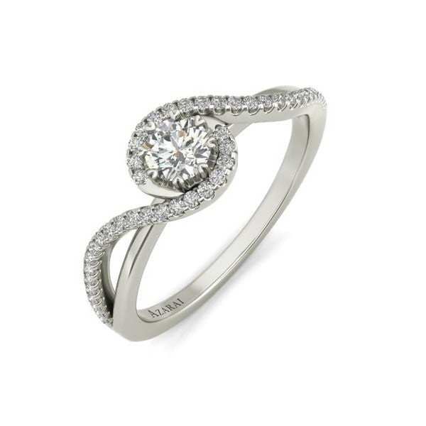 A white gold engagement ring with a diamond halo.