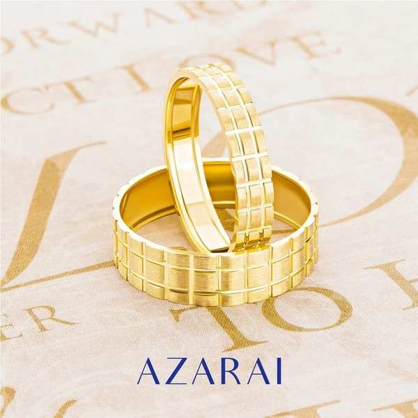 Two gold rings with the words azari on them.