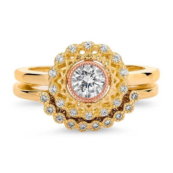 A yellow gold and rose gold engagement ring set with diamonds.