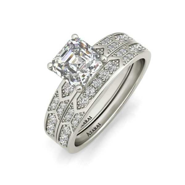 A white gold engagement ring set with a princess cut diamond.