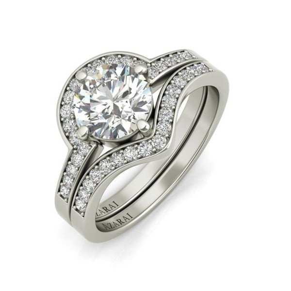 A white gold engagement ring set with a round brilliant cut diamond.