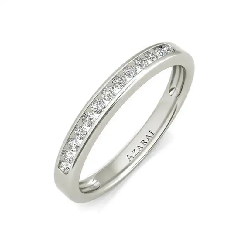 A white gold ring with a row of small round diamonds set into the band, engraved with the word "AZARAI" on the inside.