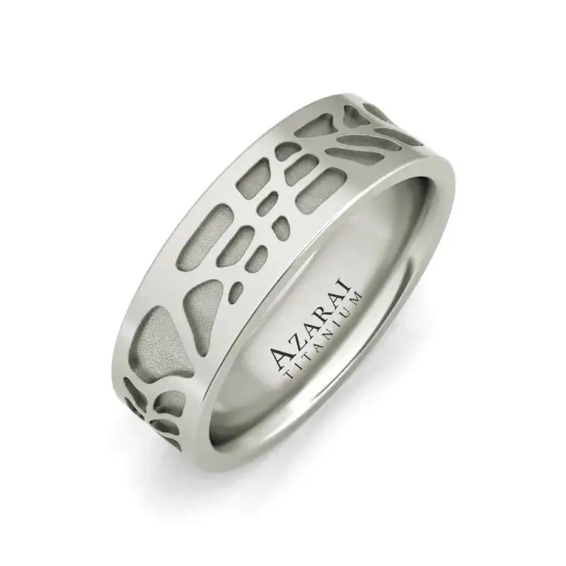 A titanium ring with an abstract cutout pattern and "AZARAI TITANIUM" engraved on the inner band.