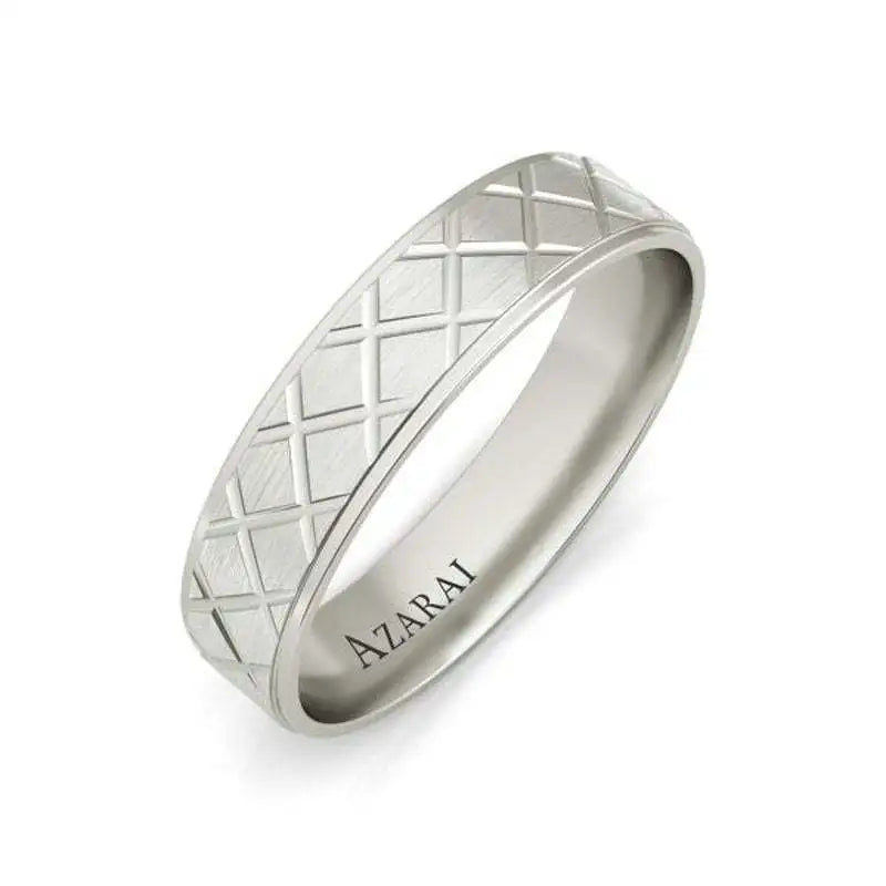 A silver ring with a crisscross engraved pattern and the word "AZARAI" inscribed on the inner band, displayed on a white background.