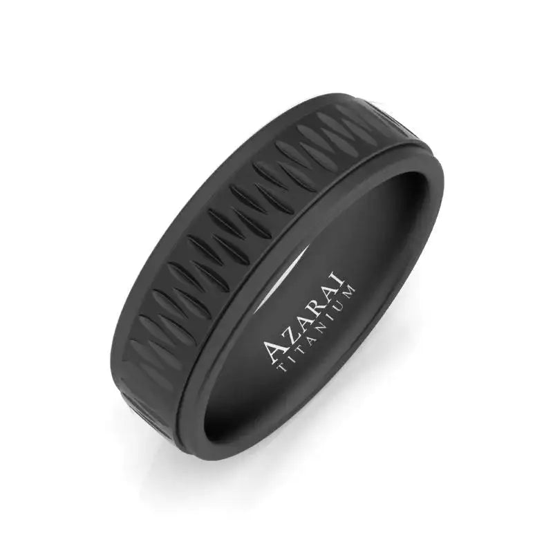 Matte black titanium ring with a raised, zigzag pattern around the band; "AZARAI TITANIUM" engraved on the inner surface.