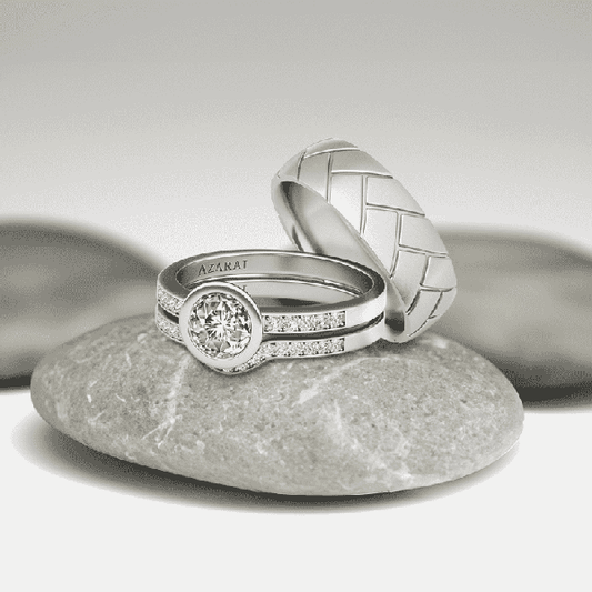 A pair of elegant Sterling silver Mix And Match Trio CLEARANCE bundle rings, one with a diamond centerpiece, displayed on smooth stones. FINAL SALE.