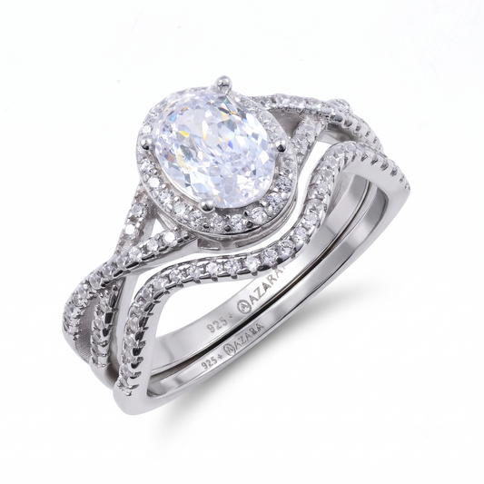 Two sterling silver rings from the Camille sterling silver bridal set, featuring oval-shaped center gemstones and small accent stones, marked "925 AZARA," elegantly displayed on a white background.