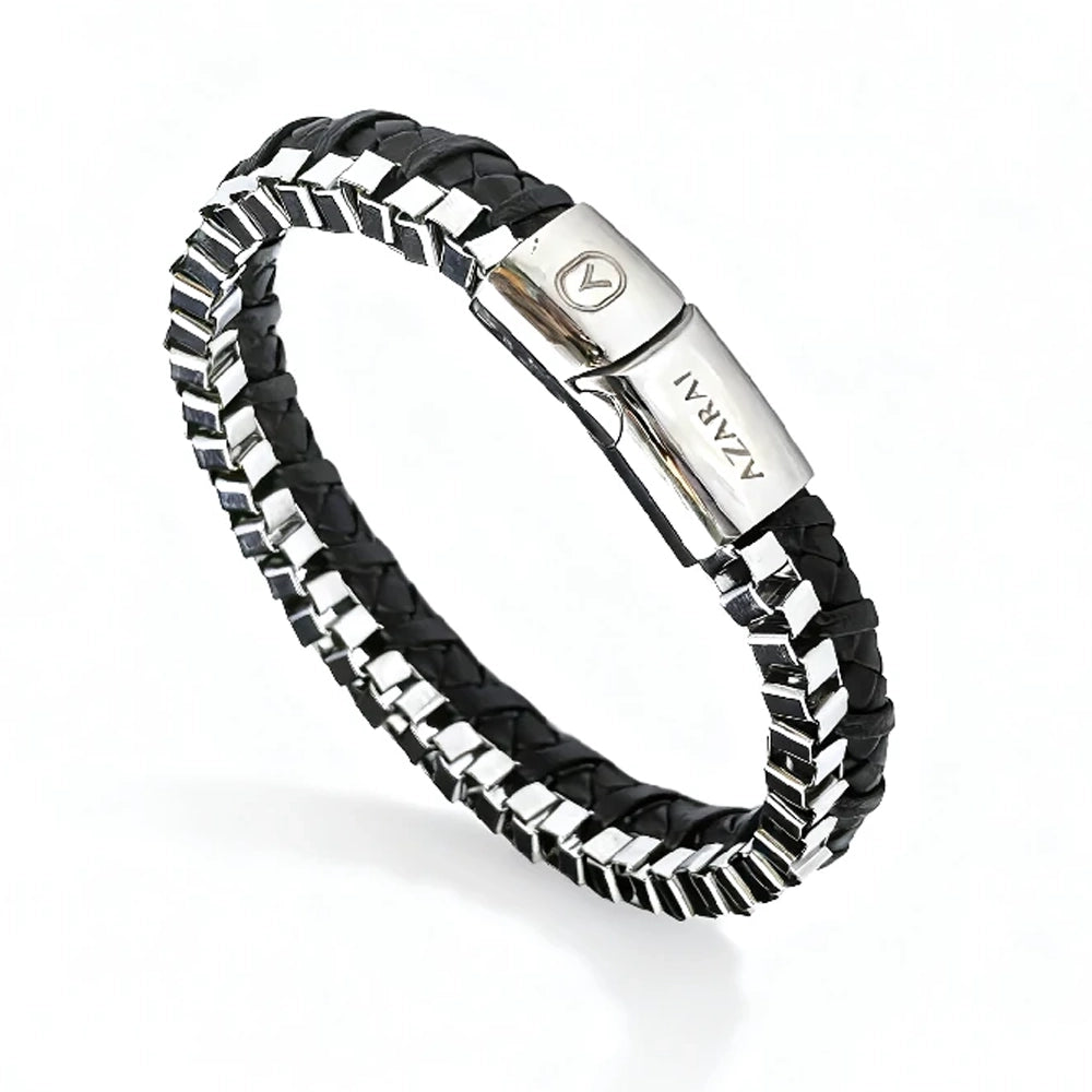 The Dualex Leather Chain Men's Bracelet is a black braided leather accessory with silver metal accents and clasp, featuring dual-material design and engraved details on the clasp.