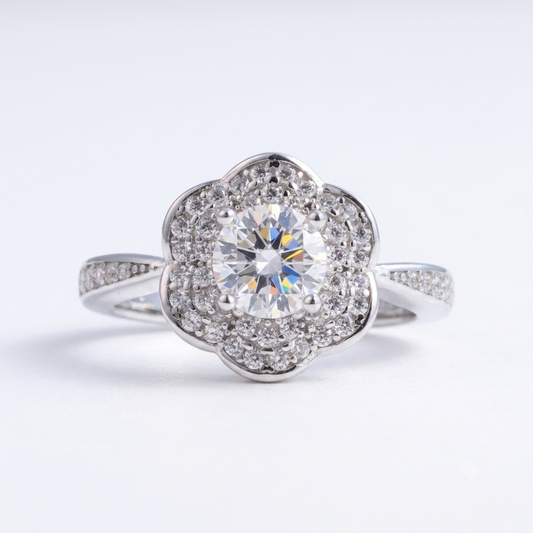 This Daisy sterling silver engagement ring features a round central diamond, surrounded by a floral-shaped halo of smaller diamonds and diamond accents on the band.