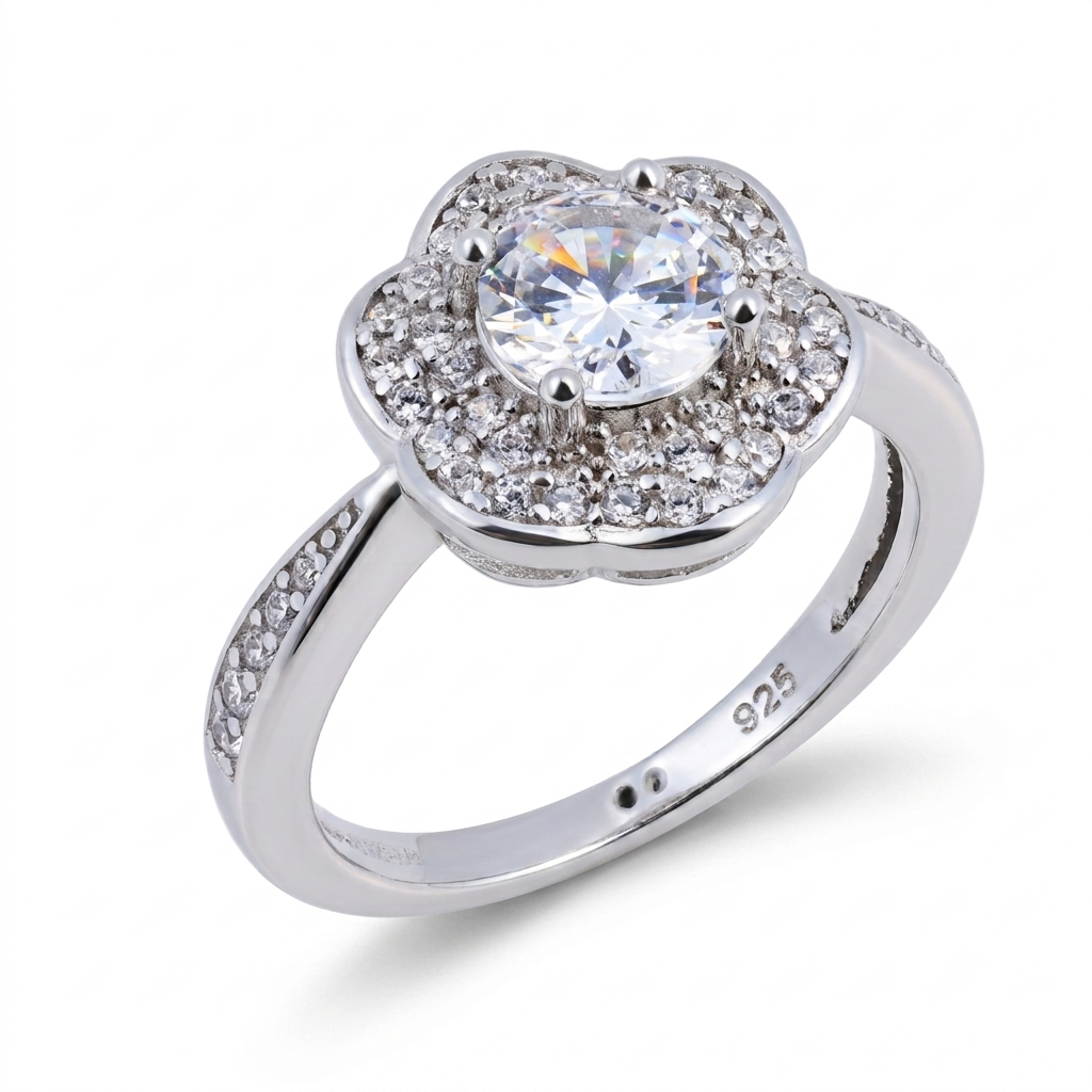 Introducing the Daisy sterling silver engagement ring, crafted in gleaming 925 sterling silver and showcasing a round central gemstone surrounded by smaller stones in an elegant floral motif evocative of a daisy. Additional sparkling stones are set along the band for extra brilliance, while the "925" stamp inside guarantees both authenticity and sophistication.