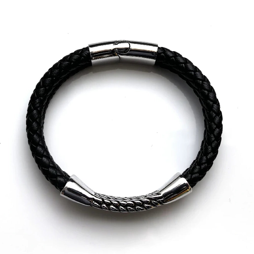 The Harvest Braided Leather Men's Bracelet features black braided leather, a stainless steel centerpiece, silver metal clasp, and decorative silver detailing, displayed on a white background.