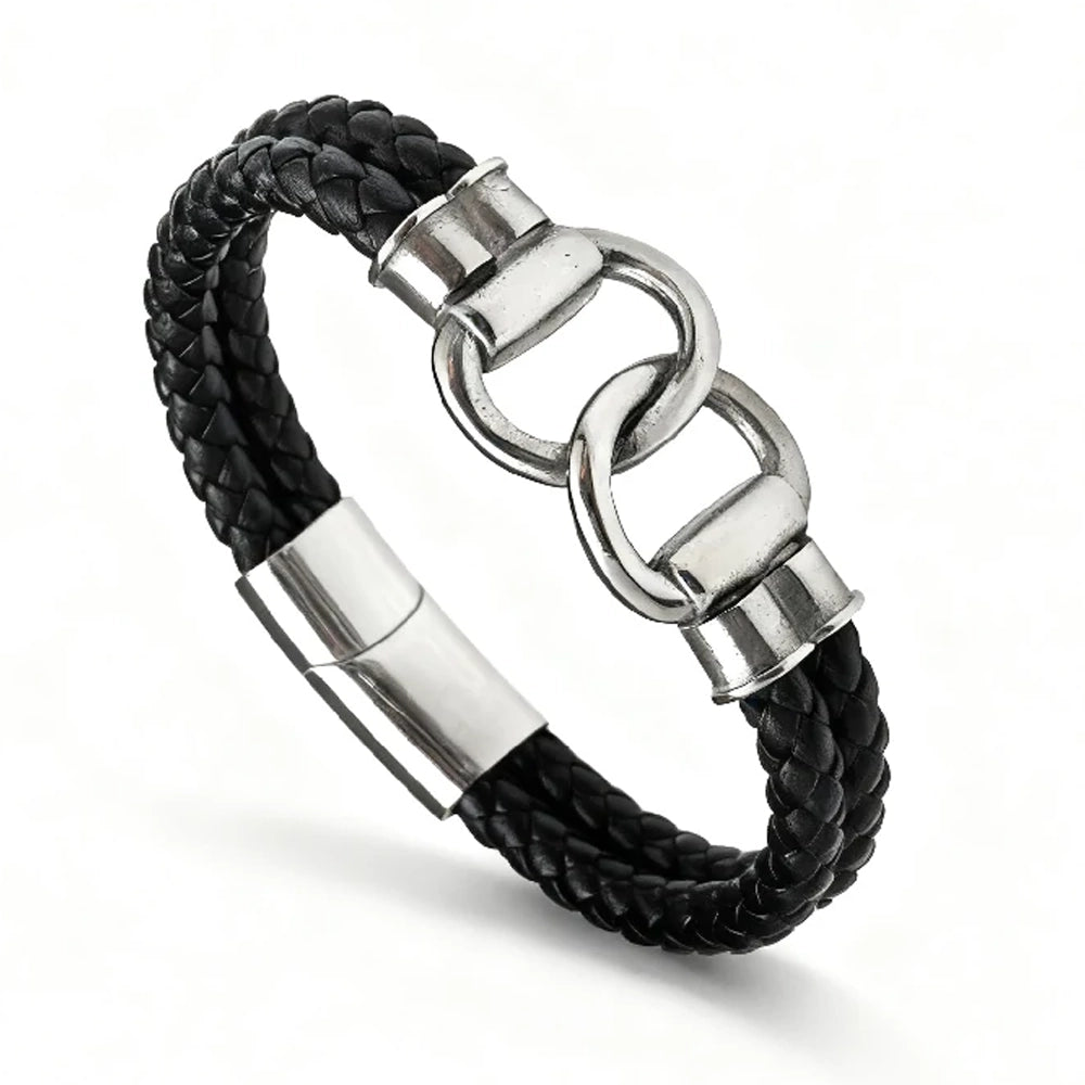 The Hinge Braided Leather Men's Bracelet showcases a black leather band with a stainless steel clasp and two interlocking infinity links as its central feature.