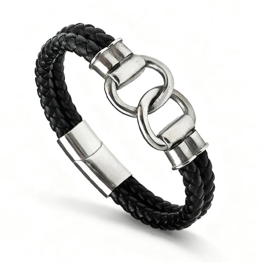 The Hinge Braided Leather Men's Bracelet showcases a black leather band with a stainless steel clasp and two interlocking infinity links as its central feature.