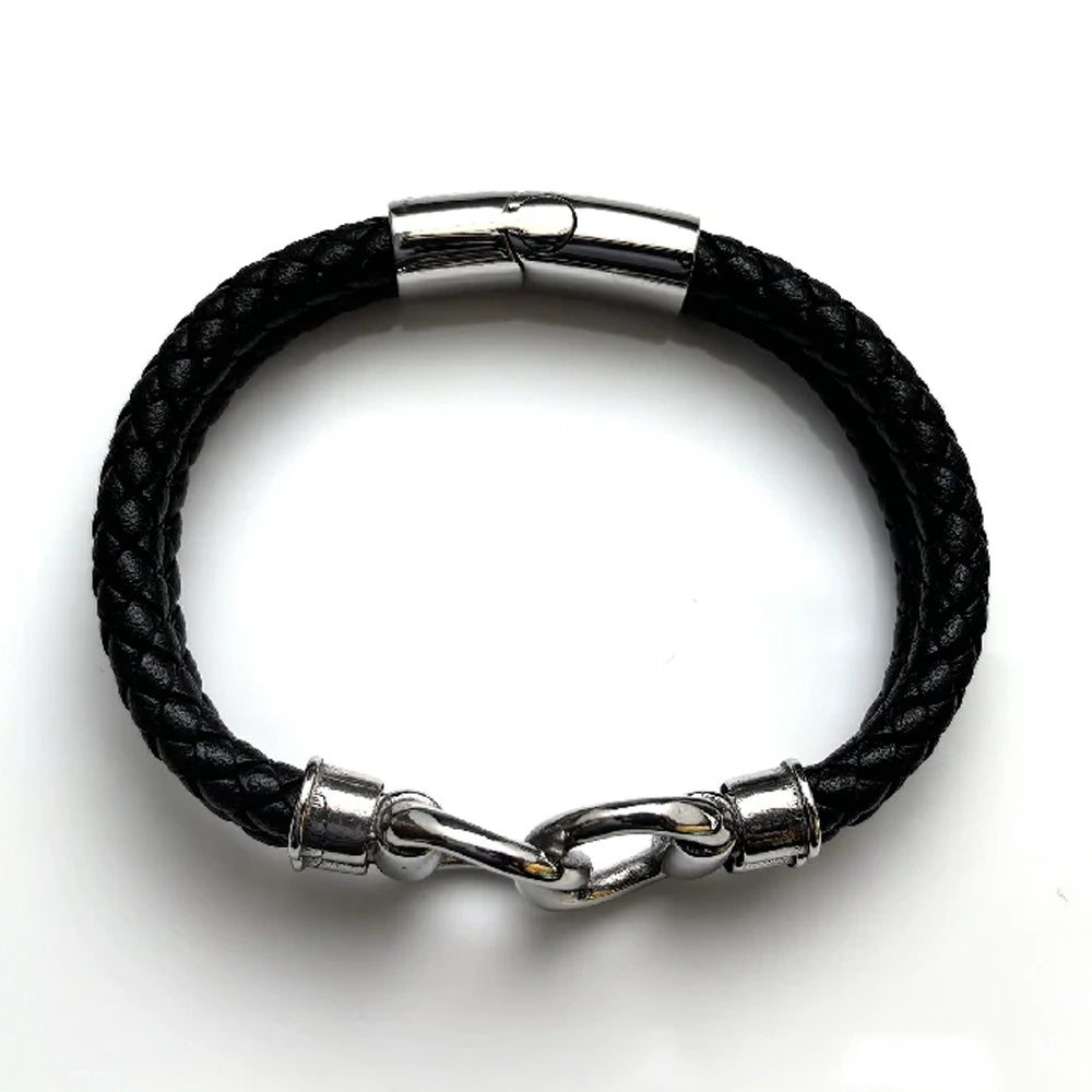The Hinge Braided Leather Men's Bracelet is shown on a white background, featuring black braided leather, an infinity link, stainless steel hook closure, and silver metal clasps.