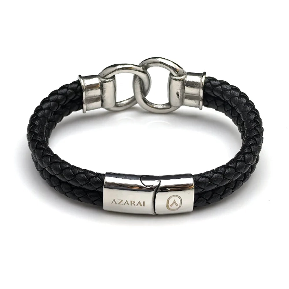 The Hinge Braided Leather Men's Bracelet features black leather with a silver stainless steel clasp and hardware, engraved with the "AZARAI" brand name.