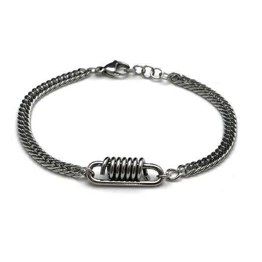 The Ignition Stainless Steel Men's Bracelet features a central metal coil detail and lobster clasp, blending automotive-inspired style with a modern twist on the classic Franco chain design.