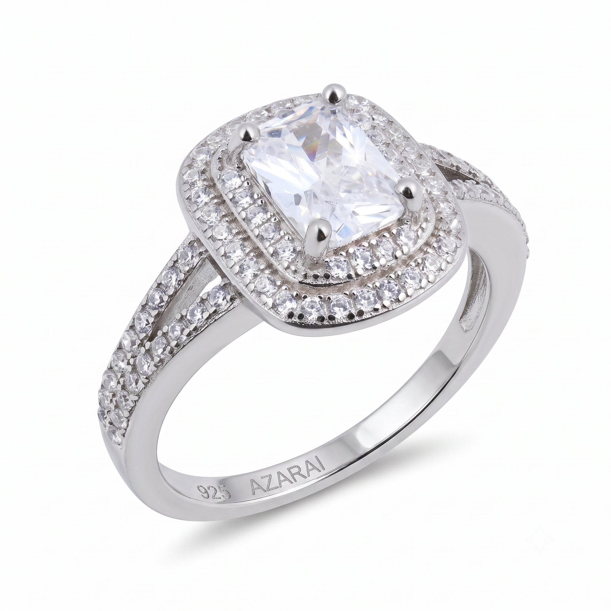 Celebrate your love story with the Lina sterling silver engagement ring, featuring a cushion-cut center stone surrounded by a dazzling double halo of smaller gems. The split shank band sparkles with additional accents and is stamped "925 AZARAI" on the inside, ensuring genuine style and craftsmanship.