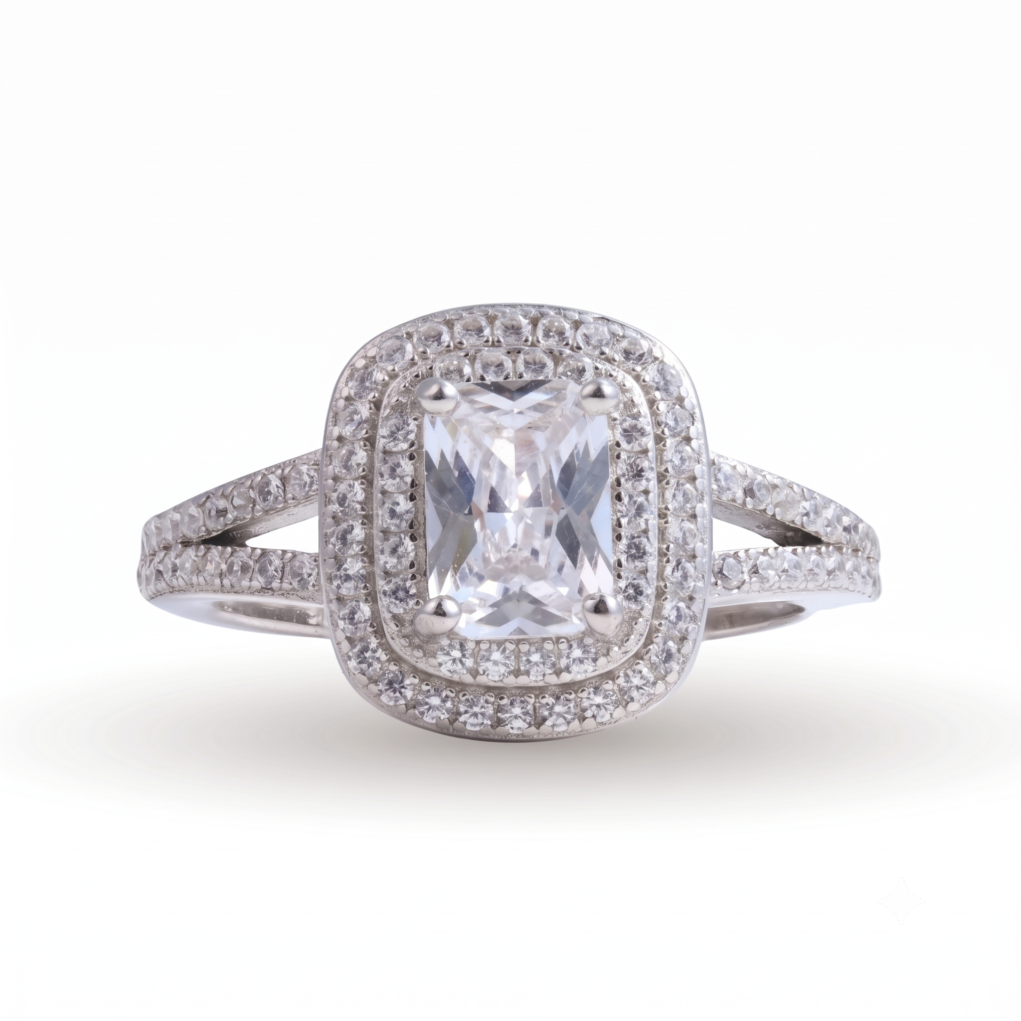 A striking Lina sterling silver engagement ring, featuring a rectangular center gemstone surrounded by two rows of small round diamonds, with a split shank band also set with diamonds.
