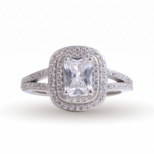 A striking Lina sterling silver engagement ring, featuring a rectangular center gemstone surrounded by two rows of small round diamonds, with a split shank band also set with diamonds.