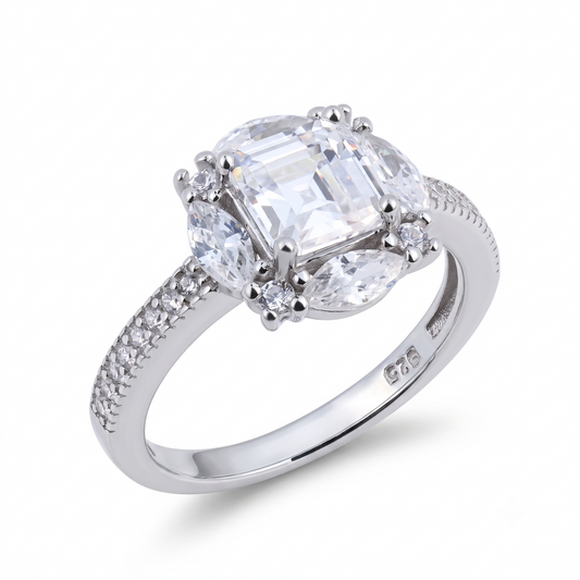 The Mulan sterling silver engagement ring features a large rectangular clear gemstone at its center, flanked by two oval stones and delicate round accents, with additional sparkling stones set along the band—an elegant and striking piece inspired by Mulan’s strength, perfect for an unforgettable engagement.