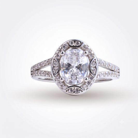 The Mylania sterling silver engagement ring showcases a breathtaking oval-cut clear gemstone at its center, accented by smaller sparkling stones along a delicate split shank band for an elegant and timeless look.