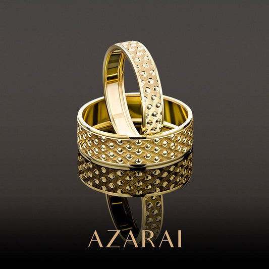 Two Bailey 9kt gold wedding bands with the word azarai on them.