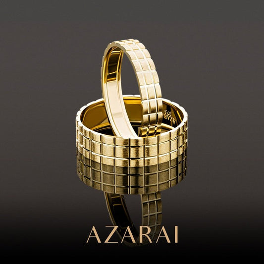 A pair of Mozaic 9kt gold wedding bands with the word azarai on them, perfect as men's wedding bands.