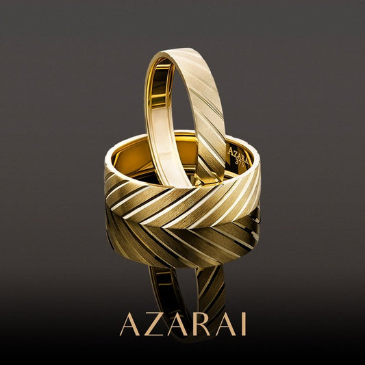 A pair of Nikolai-designed Nikolai 9kt gold wedding bands engraved with the word azarai.