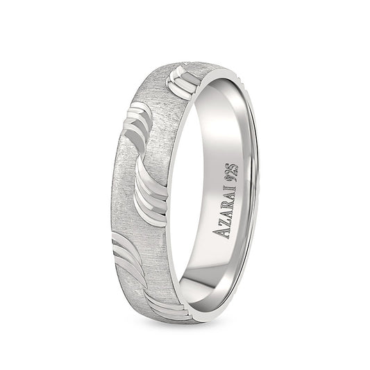 A Breton sterling silver wedding band with a wave pattern.