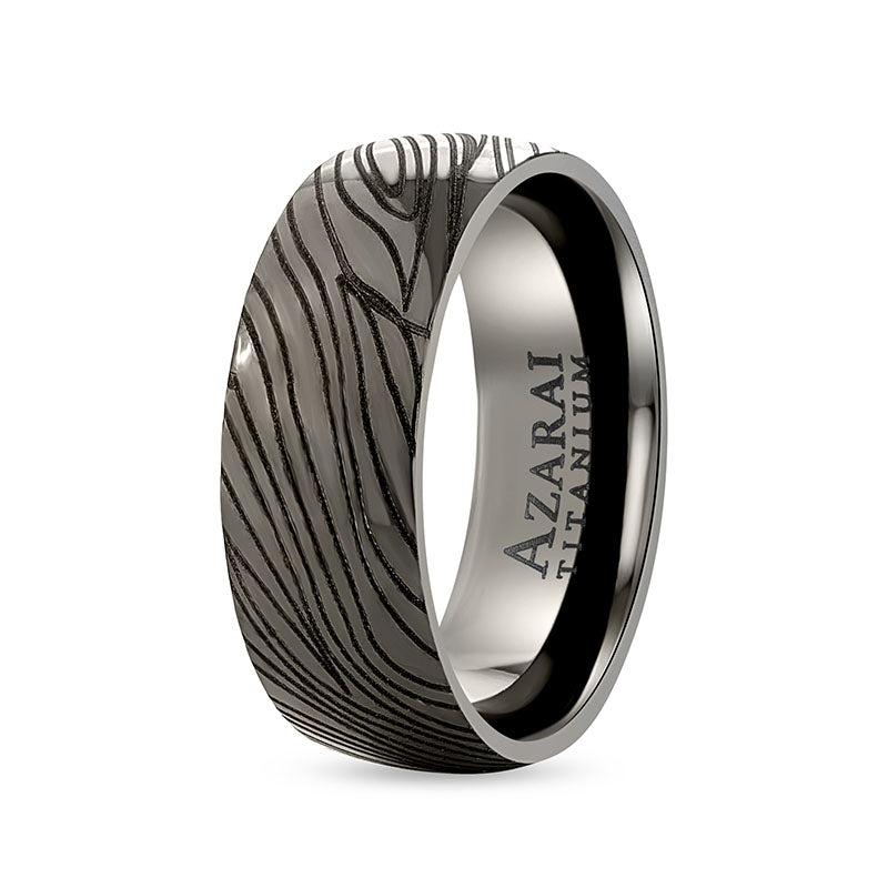 An Umbra black titanium wedding band with a black zebra pattern.