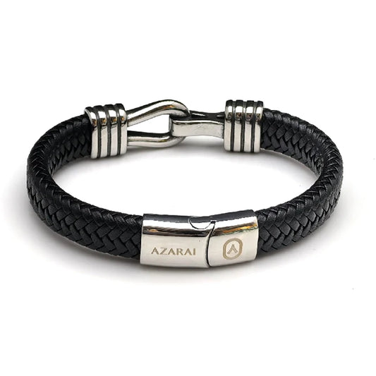The Stirrup Braided Leather Men's Bracelet features black braided leather, a stainless steel clasp engraved with "AZARAI," and silver accents—creating a sleek design inspired by classic equestrian jewelry.