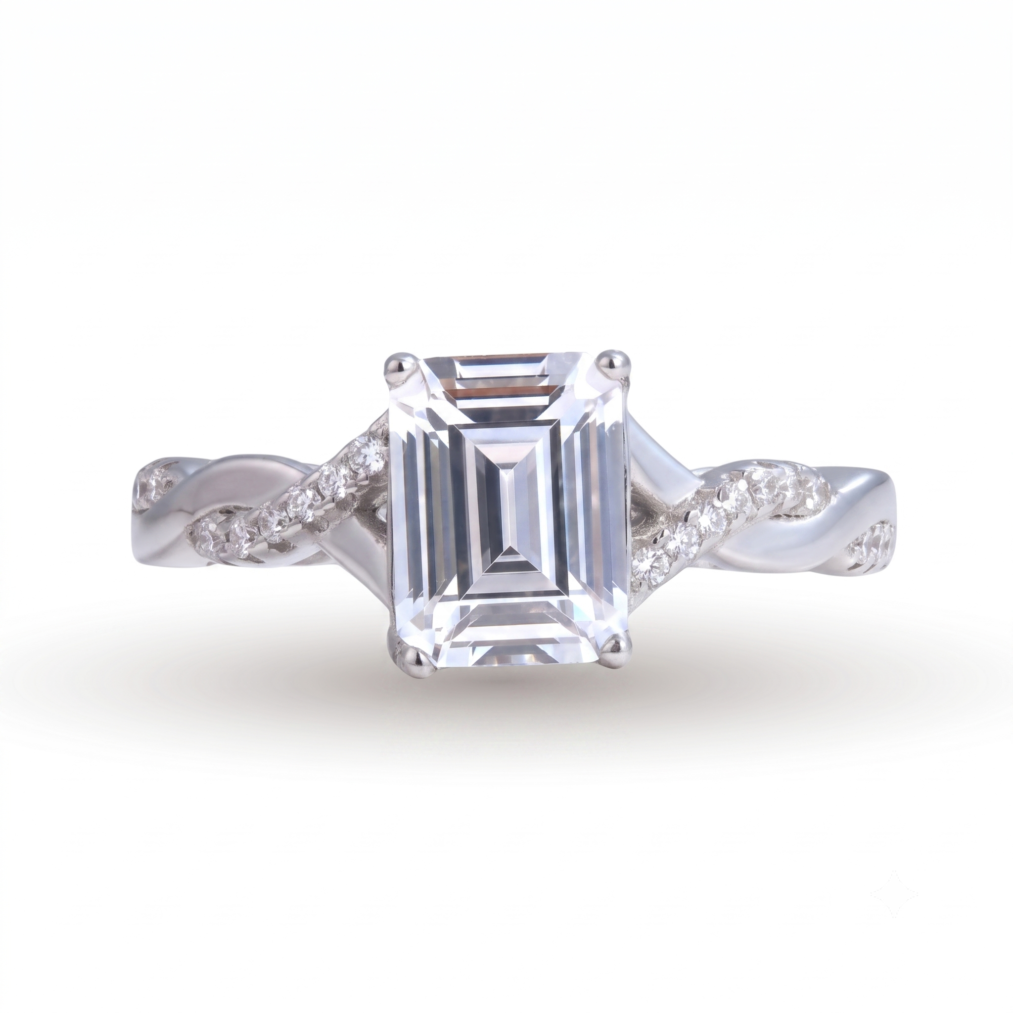 Sia Emerald sterling silver engagement ring featuring a large emerald-cut clear gemstone and small round diamonds set in a twisted band design, shown on a white background.