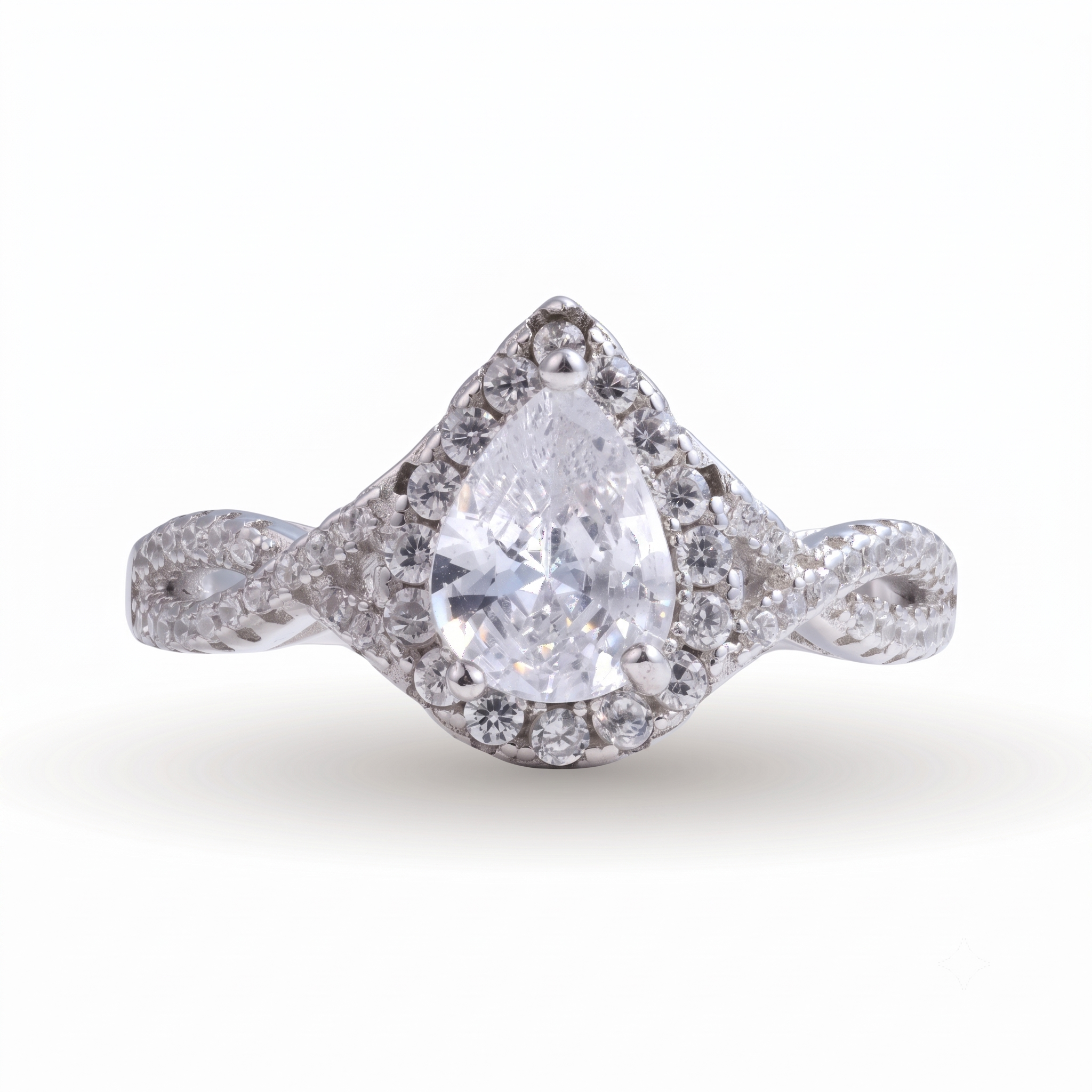 Sia Pear sterling silver engagement ring showcasing a pear-shaped diamond encircled by a halo of smaller diamonds and set on a twisted sterling silver band, displayed against a white background.