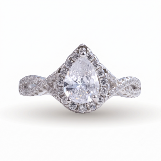 Sia Pear sterling silver engagement ring showcasing a pear-shaped diamond encircled by a halo of smaller diamonds and set on a twisted sterling silver band, displayed against a white background.