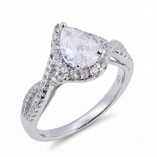 The Sia Pear sterling silver engagement ring features a brilliant pear-shaped clear gemstone at its center, complemented by smaller round stones elegantly set along the band.