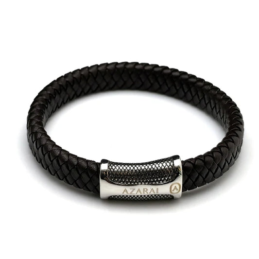 The Treso Braided Leather Men's Bracelet features dark brown braided leather and a stainless steel bar clasp engraved with "AZARAI" and a logo, making it a stylish accessory for men.