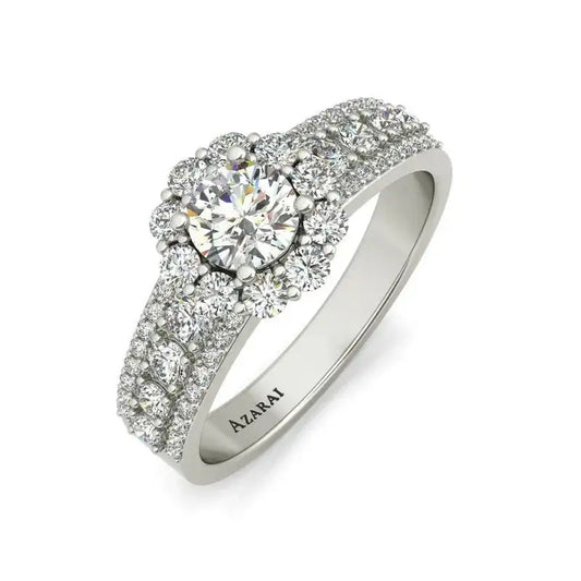 The Auburn 9kt gold engagement ring features a round central diamond encircled by smaller diamonds, with the upper half of the band also adorned with diamonds. Crafted from exquisite 9kt gold, it has the brand name "Azarai" engraved inside, resulting in a captivating masterpiece.