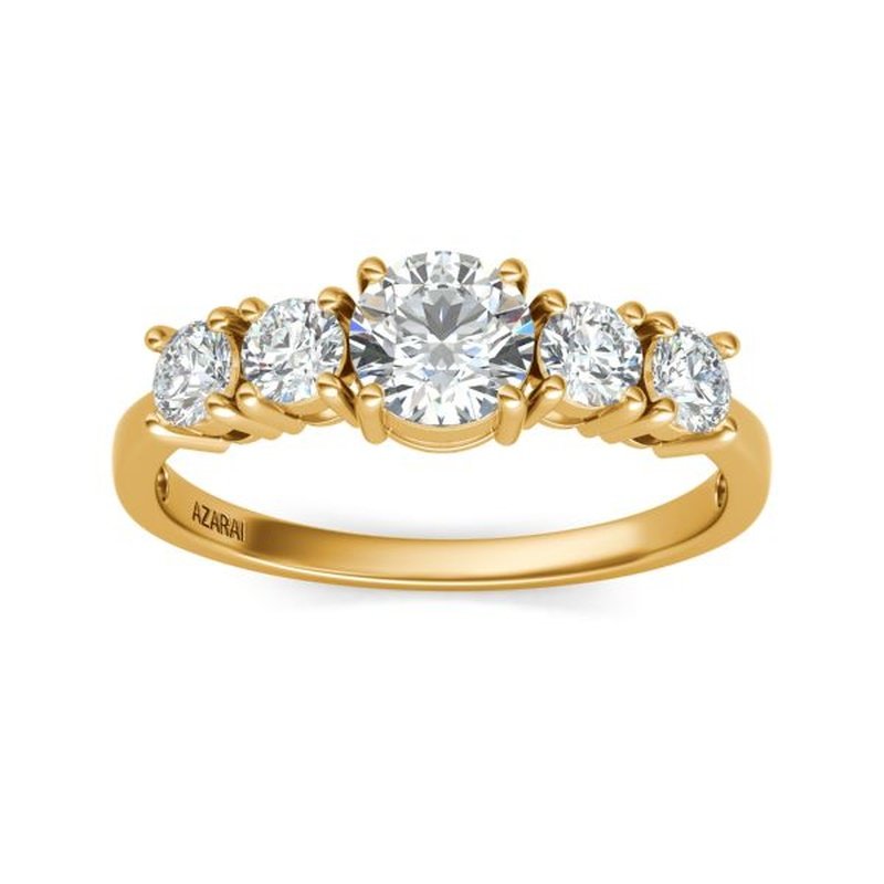 A Circa 9kt gold engagement ring with four stones.