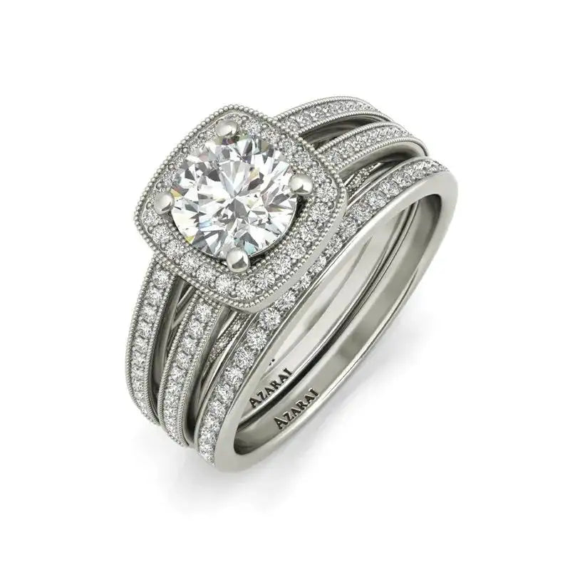 The Eva sterling silver bridal set features a dazzling diamond engagement ring with a large round center stone, pavé halo, and matching pavé band in white metal—both engraved with "A.JAFFE" for the perfect bridal jewelry.