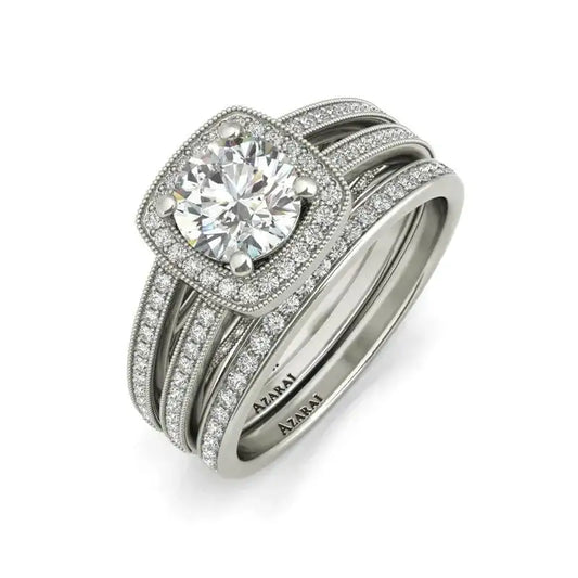 The Eva sterling silver bridal set features a dazzling diamond engagement ring with a large round center stone, pavé halo, and matching pavé band in white metal—both engraved with "A.JAFFE" for the perfect bridal jewelry.