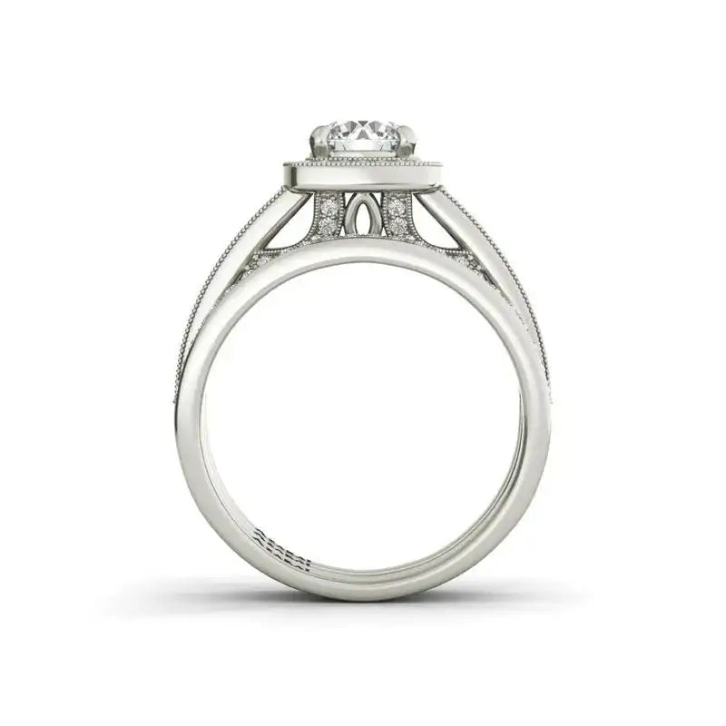 A side view of the Eva sterling silver bridal set showcases a round center diamond and intricate band detailing, echoing timeless elegance.
