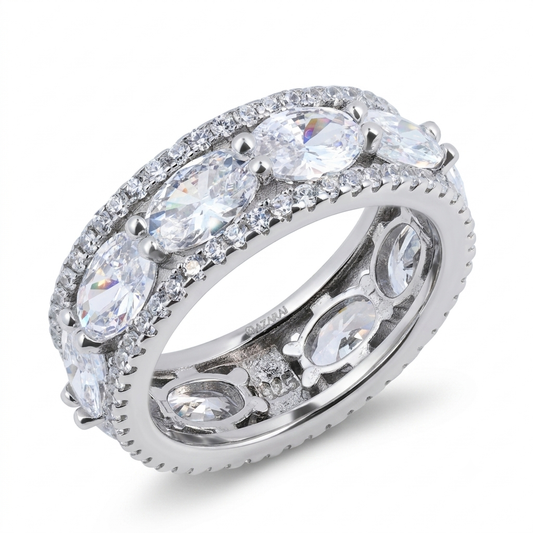 The Constantia sterling silver wedding band showcases alternating round and marquise-cut clear gemstones, accented by smaller stones set along the edges.