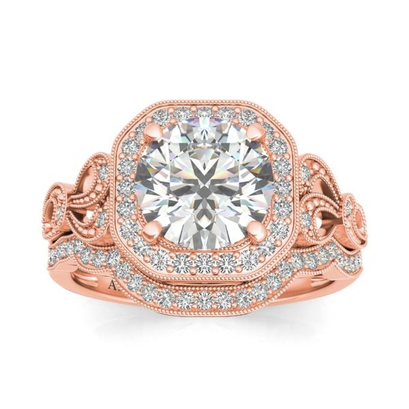 Rose gold engagement ring with a central diamond, surrounded by a halo of smaller diamonds set in an ornate, vintage-inspired Sage 9kt gold bridal set design.
