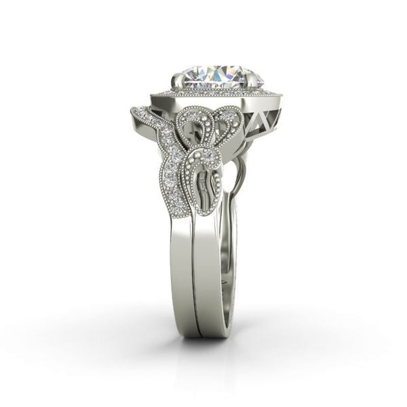 Sage 9kt gold bridal set engagement ring with an intricate band design featuring a large diamond, set against a white background.